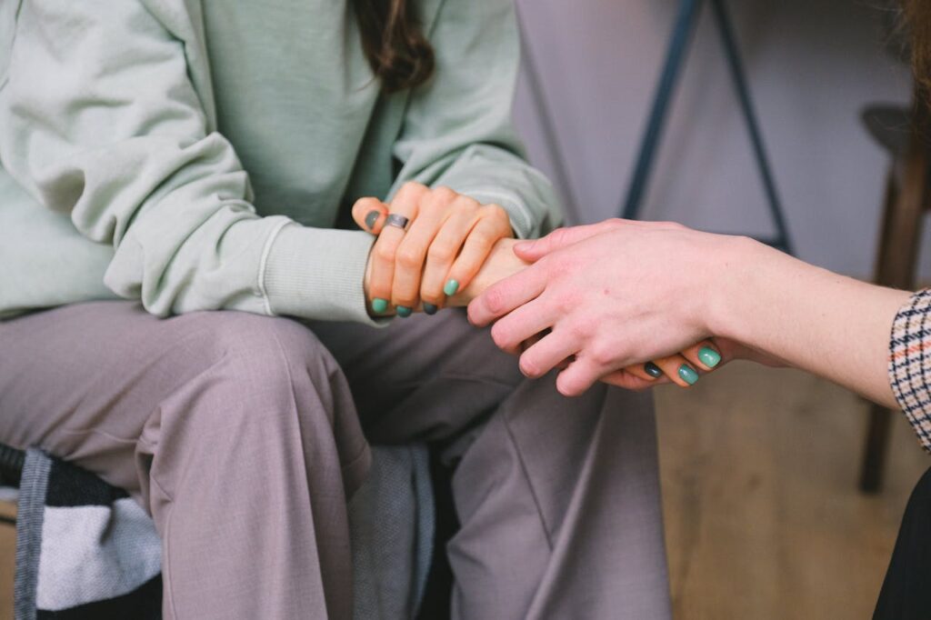 crop-psychologist-supporting-patient-during-counseling-indoors